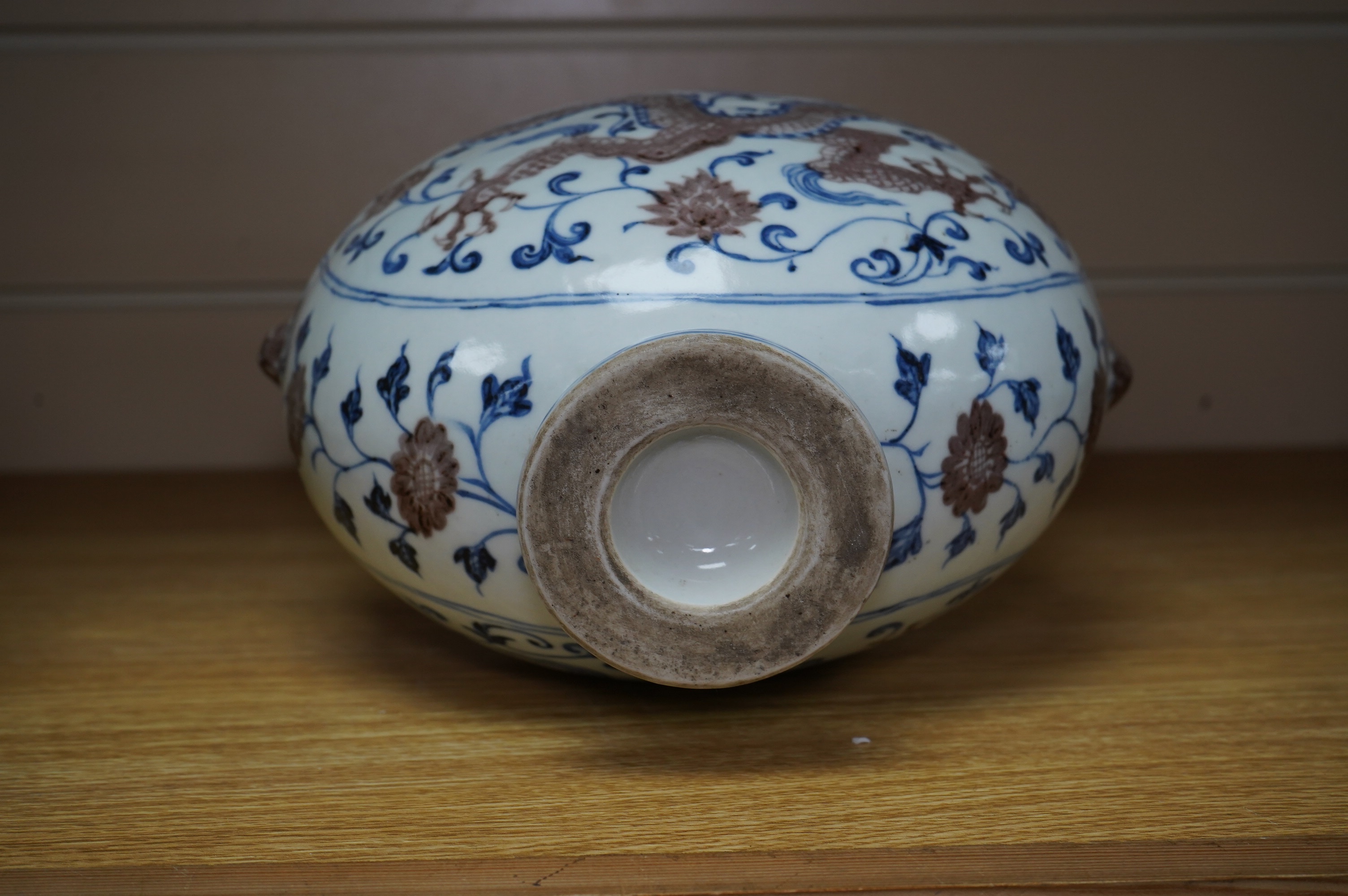 A Chinese blue and white with iron red two handled moon flask, 29cm high. Condition - good